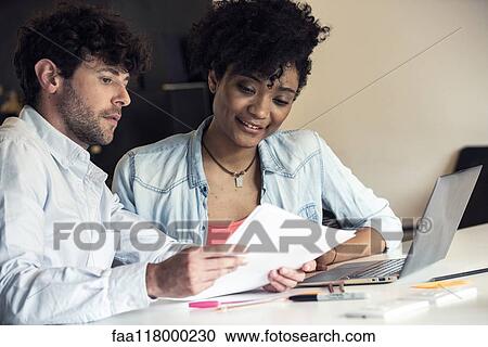Stock Image - Business people working in office. Fotosearch