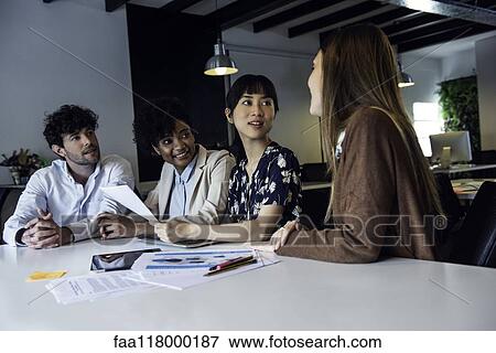 Stock Photo - Business people working in office. Fotosearch