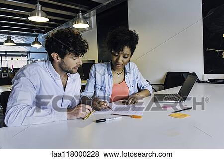 Stock Photo - Business people working in office. Fotosearch