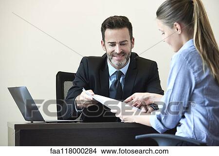 Businessman and businesswoman having meeting in office View Large Photo Image Picture - Businessman and businesswoman having meeting in office. Fotosearch