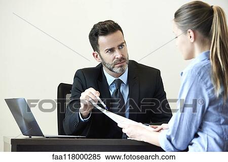 Businessman and businesswoman having meeting in office View Large Photo Image Stock Photography - Businessman and businesswoman having meeting in office. Fotosearch