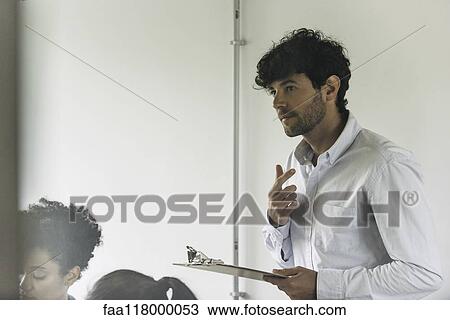 Businessman holding clipboard View Large Photo Image Stock Image - Businessman holding clipboard. Fotosearch