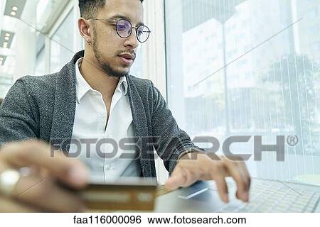 Stock Photograph - Businessman holding credit card. Fotosearch