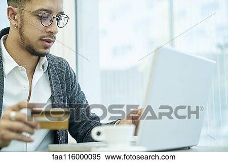 Stock Photography - Businessman holding credit card. Fotosearch