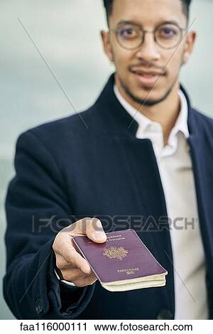 Businessman holding passport View Large Photo Image Stock Image - Businessman holding passport. Fotosearch
