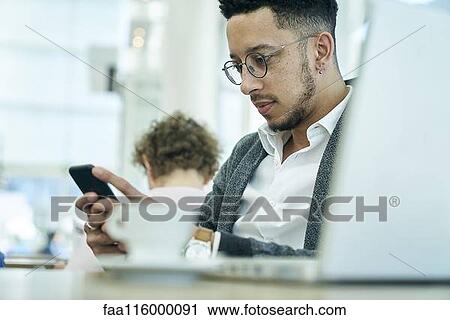 Businessman holding smartphone View Large Photo Image Stock Image - Businessman holding smartphone. Fotosearch