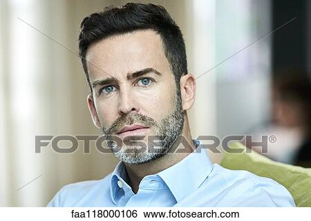 Businessman sitting in hotel lobby View Large Photo Image Stock Photograph - Businessman sitting in hotel lobby. Fotosearch
