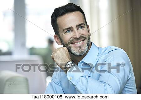 Businessman sitting in hotel lobby View Large Photo Image Stock Photography - Businessman sitting in hotel lobby. Fotosearch
