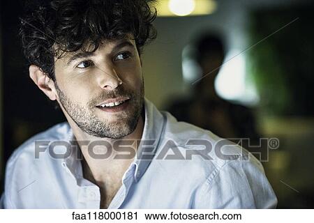 Stock Image - Businessman sitting in office. Fotosearch
