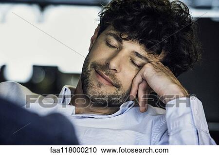 Businessman sitting in office View Large Photo Image Stock Image - Businessman sitting in office. Fotosearch