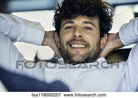 Stock Photo - Businessman sitting in office. Fotosearch