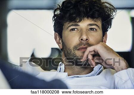 Businessman sitting in office View Large Photo Image Stock Photo - Businessman sitting in office. Fotosearch