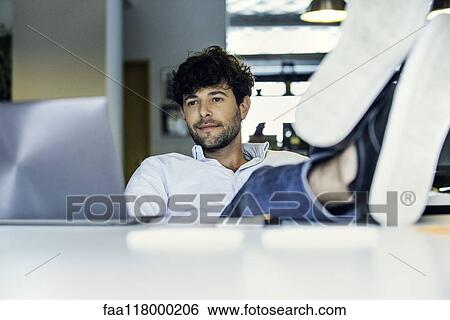 Businessman sitting in office View Large Photo Image Stock Photograph - Businessman sitting in office. Fotosearch