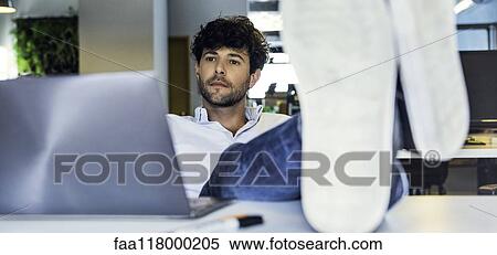 Businessman sitting in office View Large Photo Image Stock Photography - Businessman sitting in office. Fotosearch