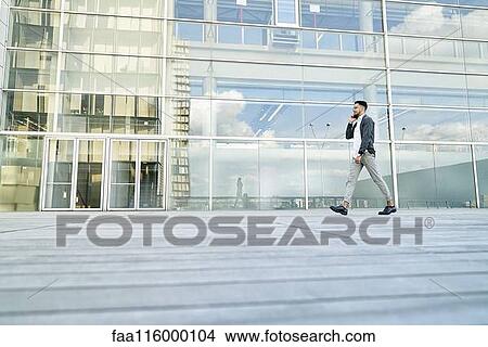 Picture - Businessman standing at outdoors. Fotosearch