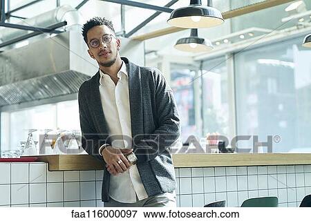 Businessman standing in restaurant View Large Photo Image Stock Photo - Businessman standing in restaurant. Fotosearch