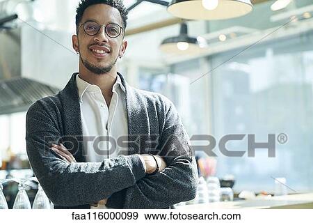 Businessman standing in restaurant View Large Photo Image Stock Photo - Businessman standing in restaurant. Fotosearch
