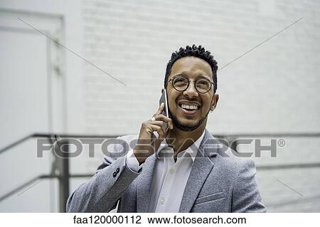 Businessman talking on smart phone View Large Photo Image Stock Image - Businessman talking on smart phone. Fotosearch