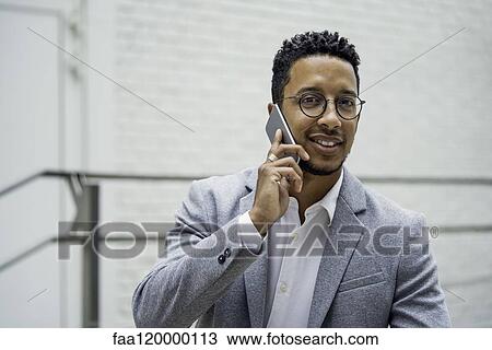 Businessman talking on smart phone View Large Photo Image Stock Image - Businessman talking on smart phone. Fotosearch
