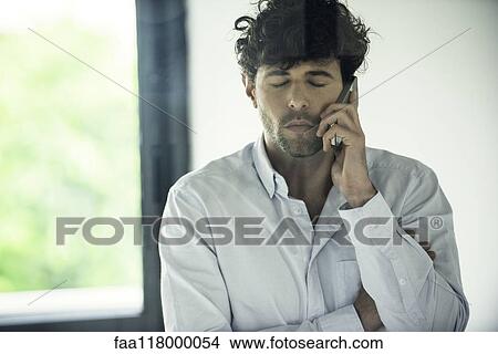 Businessman talking on smartphone View Large Photo Image Picture - Businessman talking on smartphone. Fotosearch