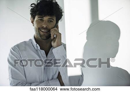 Businessman talking on smartphone View Large Photo Image Picture - Businessman talking on smartphone. Fotosearch