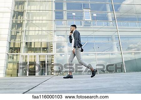 Stock Image - Businessman talking on smartphone. Fotosearch