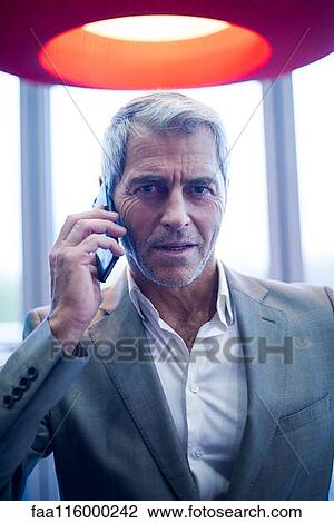 Businessman talking on smartphone View Large Photo Image Stock Image - Businessman talking on smartphone. Fotosearch