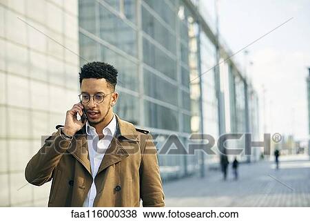 Businessman talking on smartphone View Large Photo Image Stock Photo - Businessman talking on smartphone. Fotosearch