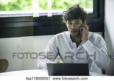 Businessman talking on smartphone View Large Photo Image Stock Photo - Businessman talking on smartphone. Fotosearch