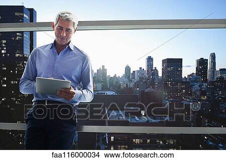 Businessman using digital tablet View Large Photo Image Picture - Businessman using digital tablet. Fotosearch