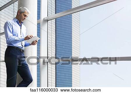 Businessman using digital tablet View Large Photo Image Stock Image - Businessman using digital tablet. Fotosearch