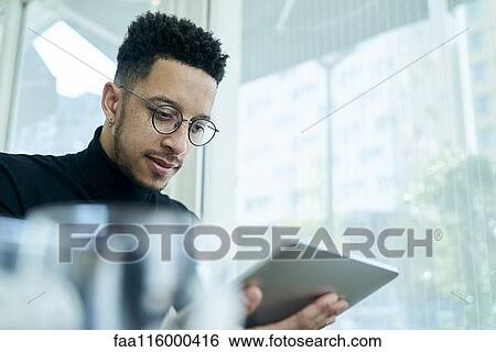 Businessman using digital tablet View Large Photo Image Stock Photograph - Businessman using digital tablet. Fotosearch