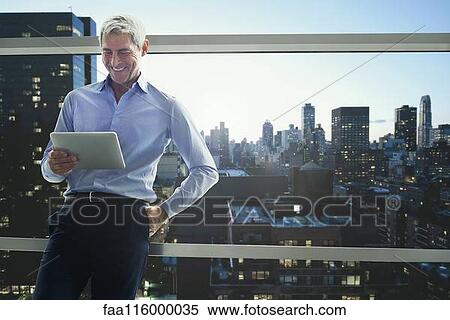 Businessman using digital tablet View Large Photo Image Stock Photography - Businessman using digital tablet. Fotosearch