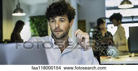 Businessman using laptop View Large Photo Image Picture - Businessman using laptop. Fotosearch