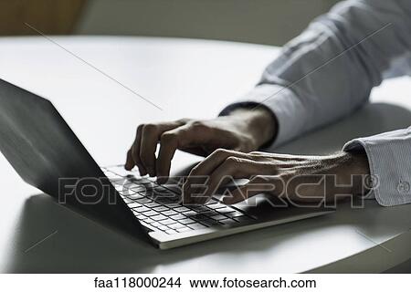 Picture - Businessman using laptop. Fotosearch