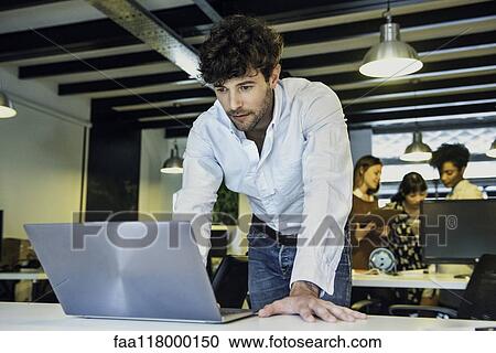 Businessman using laptop View Large Photo Image Stock Image - Businessman using laptop. Fotosearch