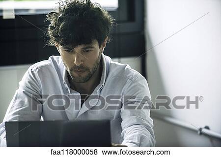 Businessman using laptop View Large Photo Image Stock Photo - Businessman using laptop. Fotosearch