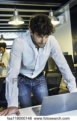 Stock Photo - Businessman using laptop. Fotosearch