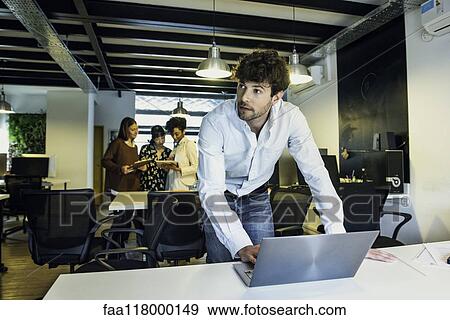 Businessman using laptop View Large Photo Image Stock Photo - Businessman using laptop. Fotosearch