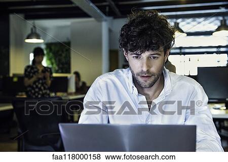 Businessman using laptop View Large Photo Image Stock Photo - Businessman using laptop. Fotosearch