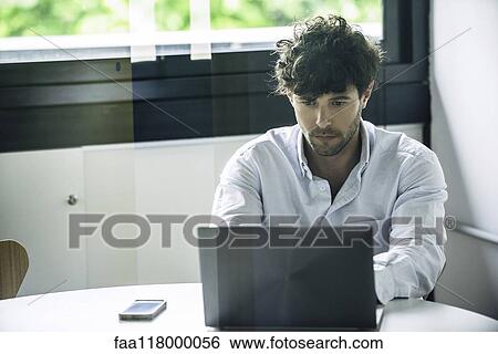 Businessman using laptop View Large Photo Image Stock Photograph - Businessman using laptop. Fotosearch
