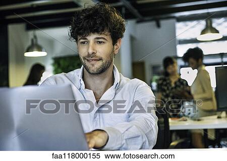 Businessman using laptop View Large Photo Image Stock Photography - Businessman using laptop. Fotosearch