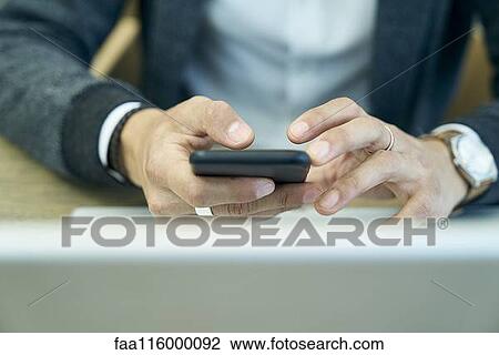 Businessman using smartphone View Large Photo Image Stock Image - Businessman using smartphone. Fotosearch