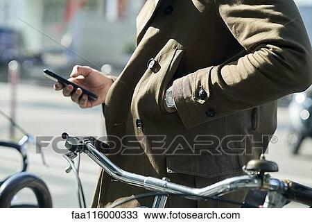 Stock Image - Businessman using smartphone. Fotosearch