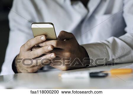 Stock Image - Businessman using smartphone. Fotosearch