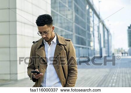 Stock Photo - Businessman using smartphone. Fotosearch