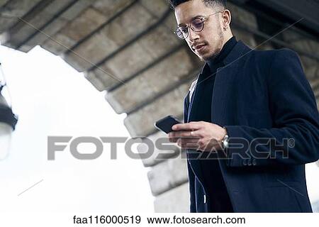 Businessman using smartphone View Large Photo Image Stock Photo - Businessman using smartphone. Fotosearch