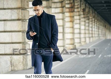 Stock Photo - Businessman using smartphone. Fotosearch