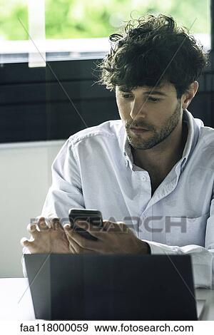 Businessman using smartphone View Large Photo Image Stock Photo - Businessman using smartphone. Fotosearch