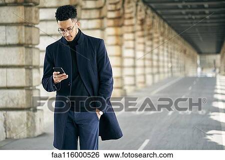 Businessman using smartphone View Large Photo Image Stock Photograph - Businessman using smartphone. Fotosearch